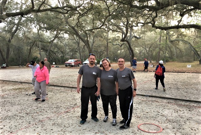 Philippe Geraud, Jeanne-Marie Browning, and Will Poire at the petanque court ready to play.